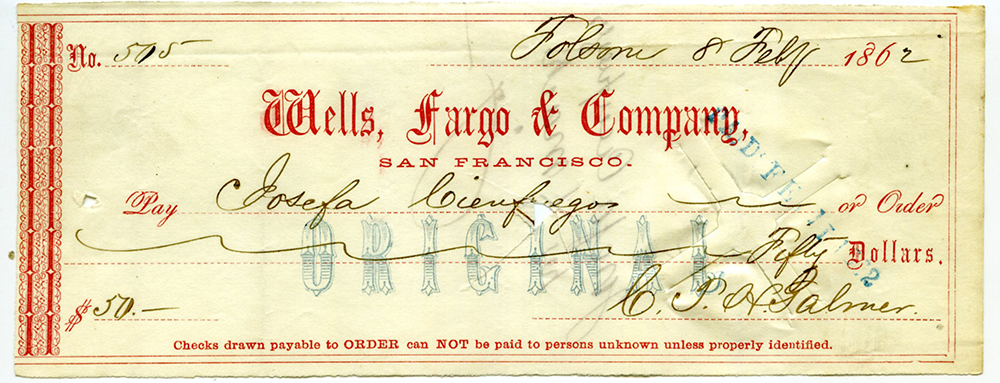 Red and white Wells Fargo check dated February 8, 1862 in black ink. Made out to Josefa Cienfeugos in the amount of fifty dollars and signed by C.T.H. Palmer.