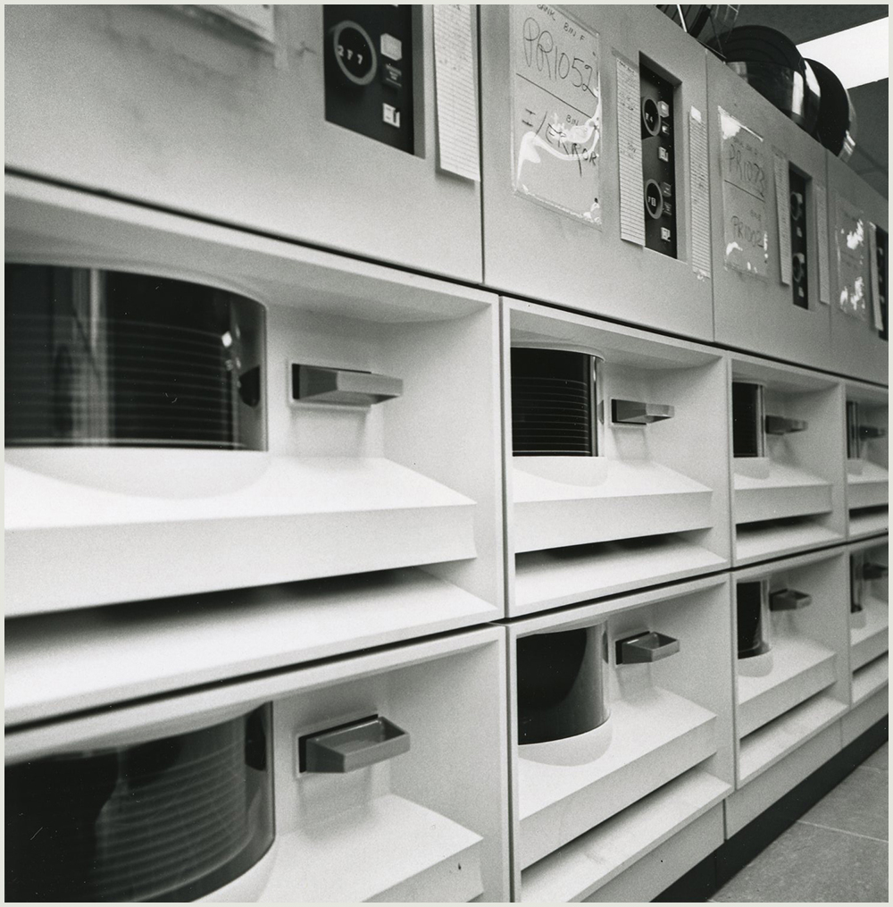 Wall of large computer equipment components, image is black and white.