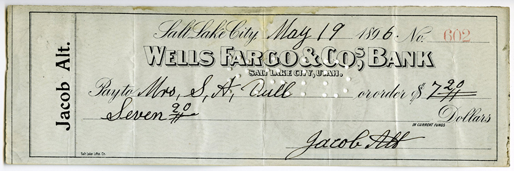 Printed bank check number 602 from customer Jacob Alt drawn on Wells Fargo & Co's Bank, Salt Lake City. Handwritten information adds payee name of Mrs. A.D. Full and amount of seven dollars twenty cents. Check is dated May 19, 1896 and is pale gray in color.