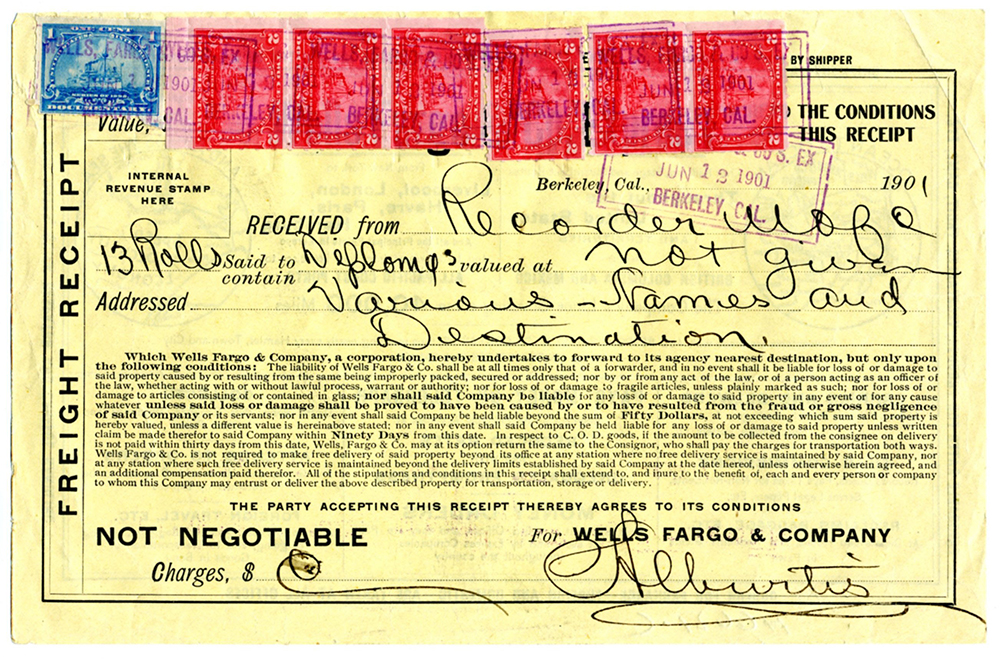 Yellow freight receipt dated June 12, 1901 at Berkeley, California. Handwritten entry received from Recorder of the University of California 13 rolls said to contain diplomas, value not given. Addressed various names and destinations. Small print paragraph detailing conditions of the receipt for shipping and liability by the company. Signed by Wells Fargo employee, illegible. One blue and six red tax revenue stamps affixed in row at top of document.