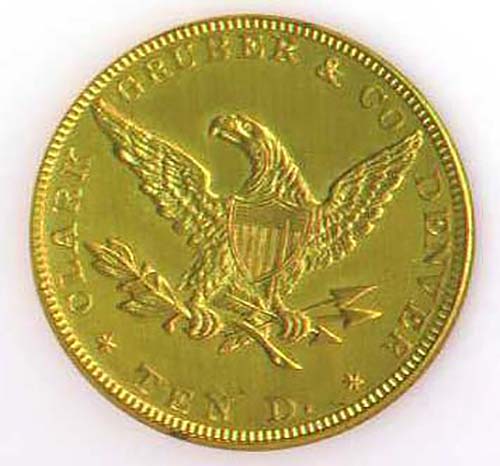 Ten dollar gold coin shows American eagle clutching olive branch and arrows in center. Name Clark Gruber & Co and Denver on edge. Color image.