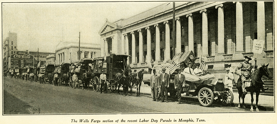 A line of wagons drawn by horses are in front of a white building with pillars and the caption reads: The Wells Fargo section of a recent Labor Day Parade in Memphis, Tennessee.