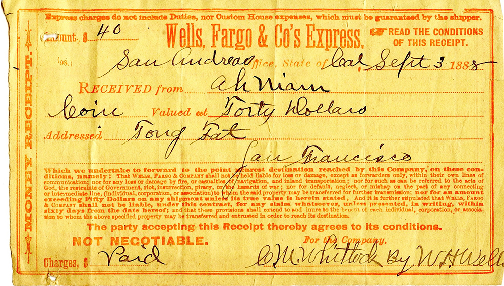 Yellow paper money receipt with printed red letters. Has handwritten instructions in black. Receipt for using Wells Fargo and Co.'s Express.