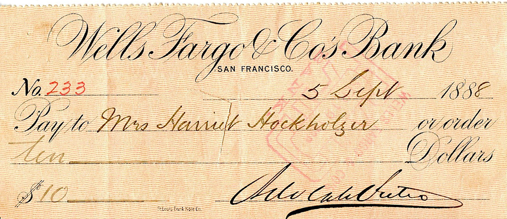 A tan colored Wells Fargo and Co. bank check written in 1888 for the total amount of $10 to Harriet Hockholzer and signed by Adolph Sutro.