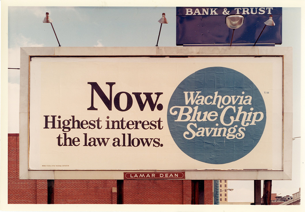 A white billboard with black print that says: Now, Highest interest the law allows. To the left is a blue circle that says: Wachovia Blue Chip Savings.