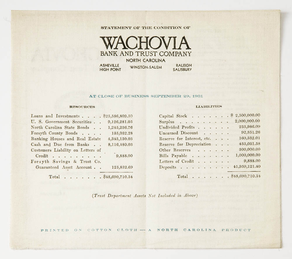 A white pamphlet for Wachovia Bank and Trust Company lines out the banks Resources and Liabilities in black print on linen fabric.
