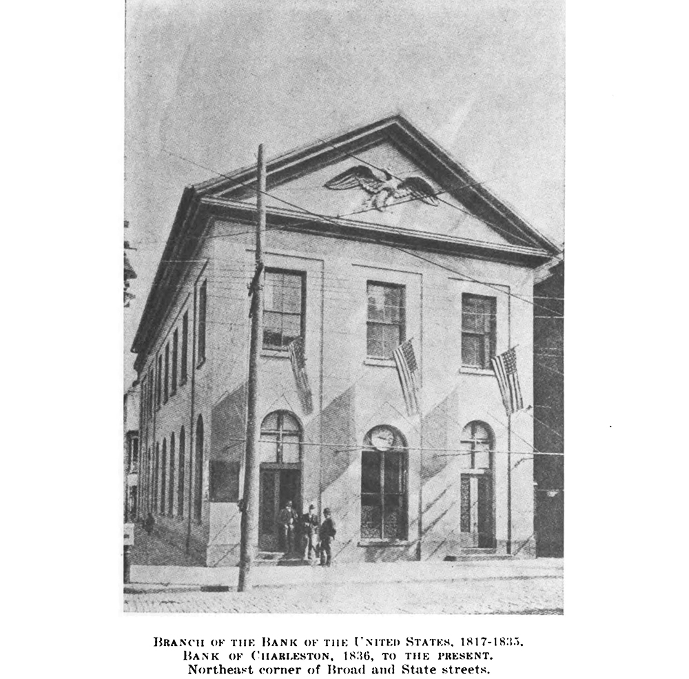 Black and white picture of a historic building in the Neo-classical style. A carved eagle sculpture is in the gable above the second floor. Three men stand in the doorway. Three American flags are hung below the second story windows. The caption reads: Branch of the Bank of the United States, 1817-1835. Bank of Charleston, 1836 to the present. Northeast corner of Broad and State Streets.