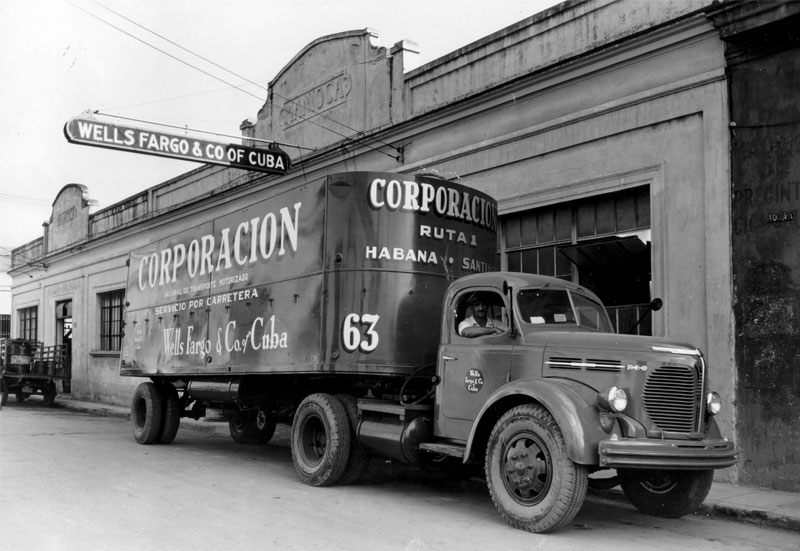 Wells Fargo truck parked outside of building with sign: Wells Fargo and Co of Cuba. Historic black and white photograph. Image link will enlarge image.