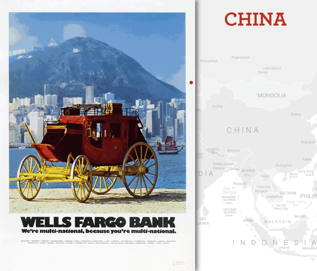 A Wells Fargo stagecoach is parked before a waterfront with the skyline of Hong Kong in the background. Image link will enlarge image.