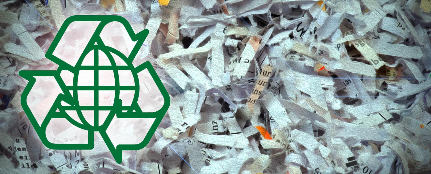A green recycling logo superimposed over a large pile of shredded papers.