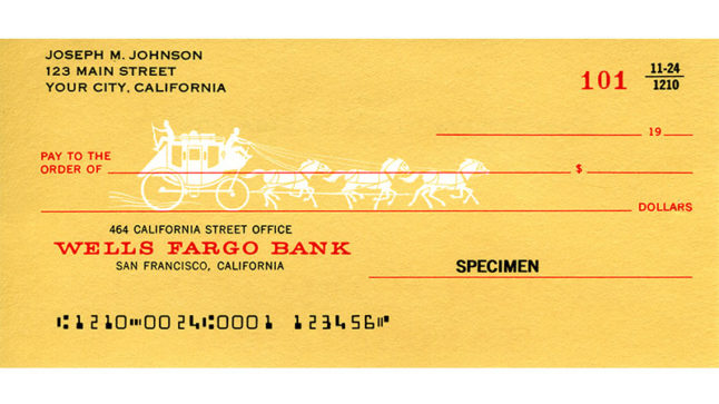 A yellow check with black and red lettering. A white stagecoach and horses silhouette runs across the Pay to the order of line.