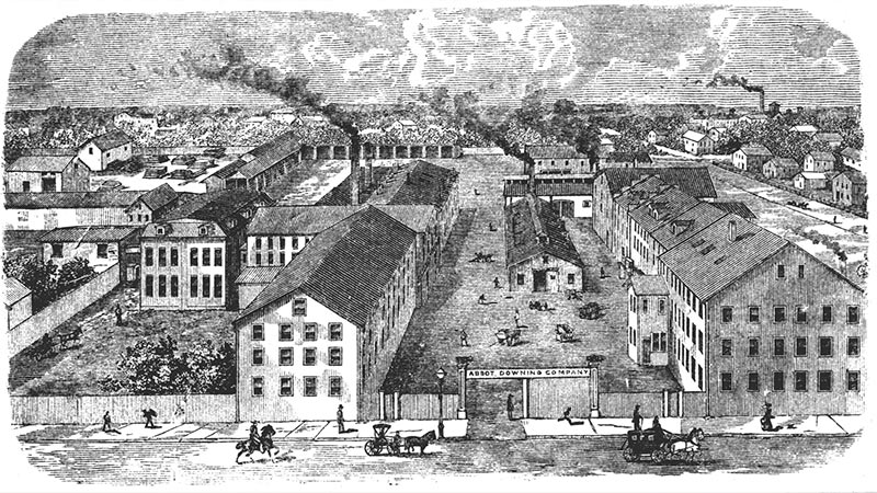 Illustration of several factory buildings with people walking in the street in the foreground and plumes of smoke rising from the buildings in the background. Image link will enlarge image.
