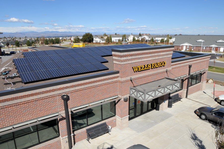 Color photograph of a solar array on top of a Wells Fargo building.