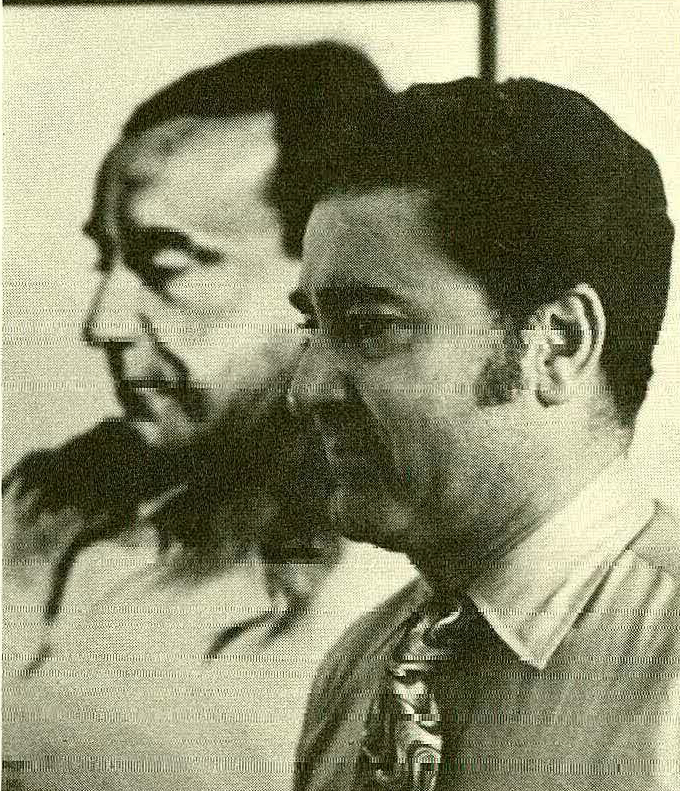 Fernando Guzman stands in front of a portrait of his father Juan Guzman Cruchaga