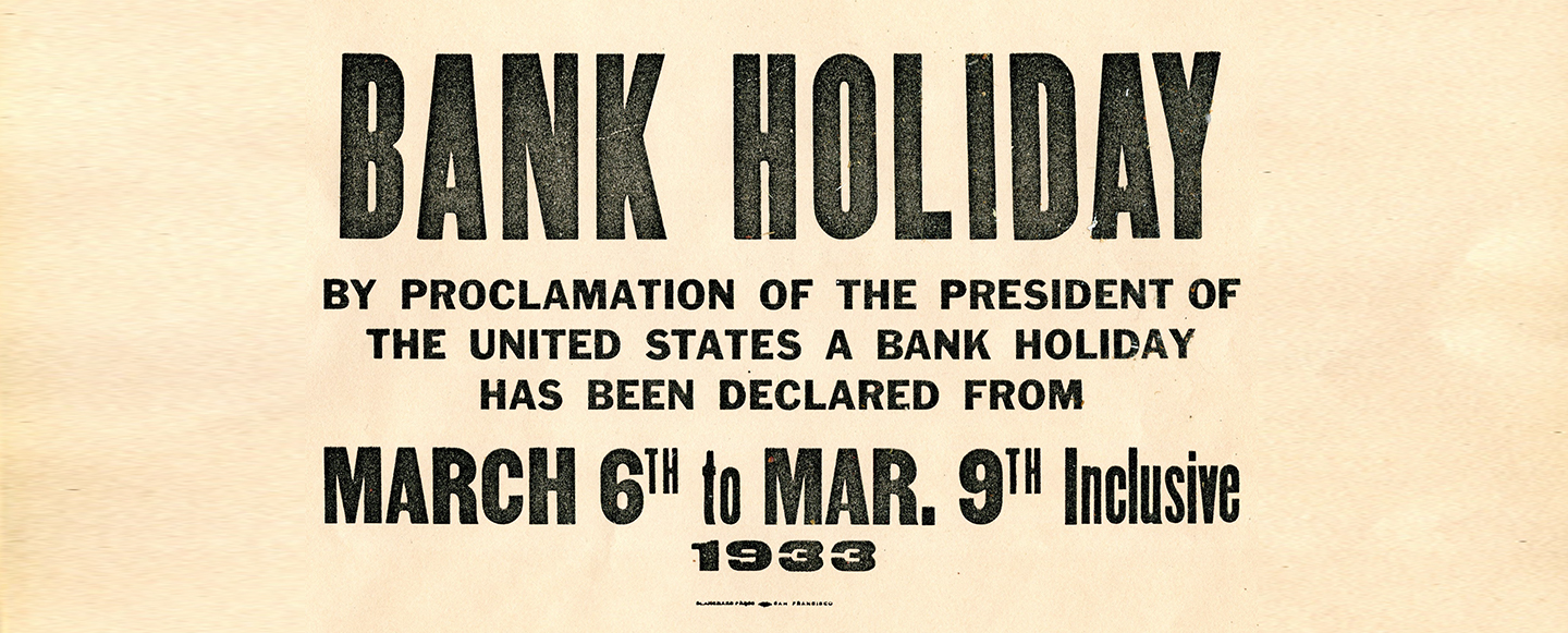 A yellow sign hung on branches from 1933 that reads: Bank Holiday by proclamation of the President of the United States a bank holiday has been declared from March 6th to March 9th Inclusive 1933.